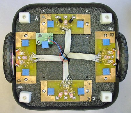 The underside of a maze-solving robot showing five circuit boards.
