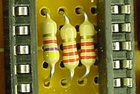 Three resistors form a voltage divider for sampling the batteries. They&rsquo;re hiding inside the microcontroller socket!