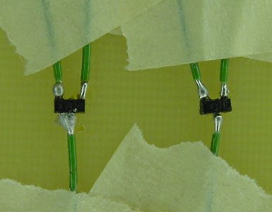 Soldering wires on surface mount transistors.