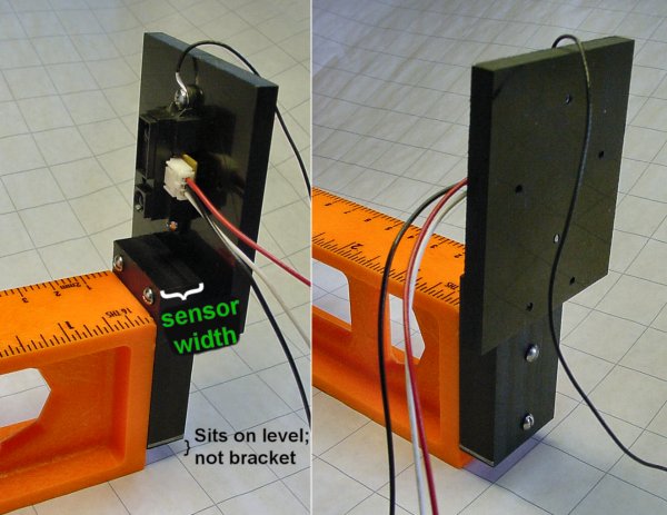 A Sharp infrared distance sensor attached to a bracket at the end of a level.