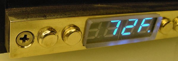 Electronic controls faced with a fancy solid brass plate with solid brass buttons.