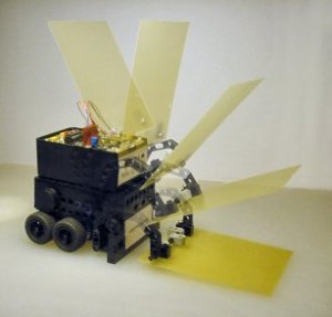 Have A Nice Day, a mini-sumo robot, lowers its scoop with a motor controlled by only a single transistor.