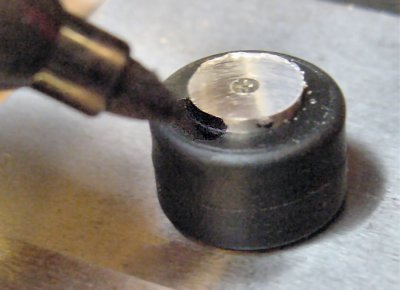 Using the LEGO tire, a black Sharpie felt-tip permanent marker marks the extra height to cut off from the aluminum hub.