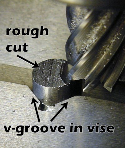 Milling flat the end of a rough cut rod. A v-groove in the milling vise holds the rod.