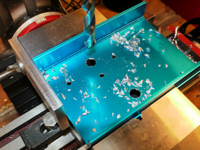 Drill smaller holes and then enlarge by drilling bigger holes