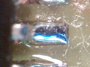 Unable to sharply focus on both the printed circuit board pads and the raised solder details at the same time