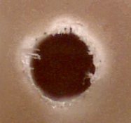 Cleanly drilled PCB hole at 60x magnification