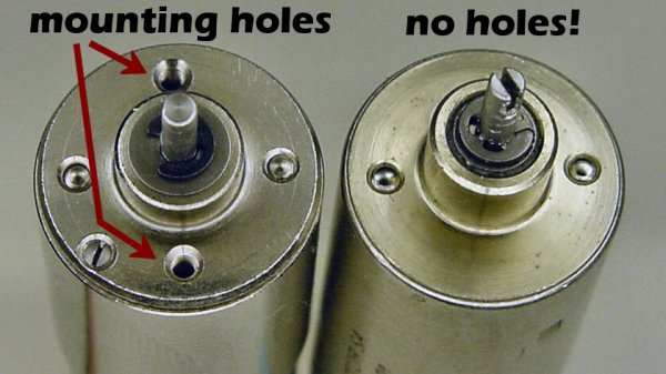 Two similar miniature electric motors. The motor on the right doesn&rsquo;t have any mounting holes.