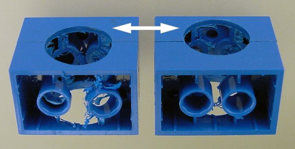 LEGO bricks glued together and drilled to accept a Maxon motor. Drill high in the pair to avoid weakening the tubes.