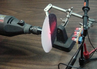 Dremel rotary tool with optical target disc and an encoder board held by a helping-hand soldering tool.