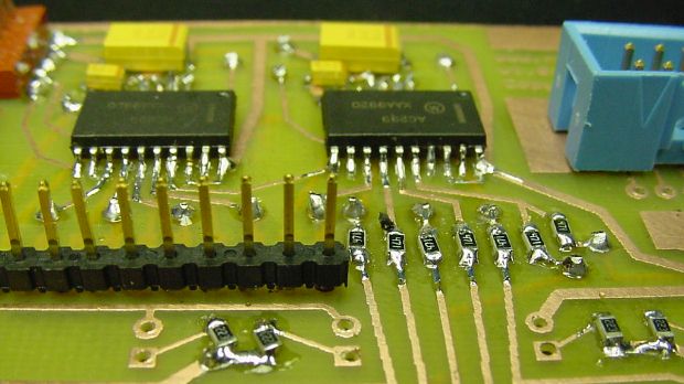 Completed double-sided PCB with surface-mounted resistors, logic chips, and capacitors