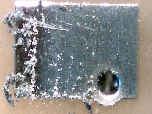 Printed circuit board pad cleaned with a Sanford Pink Pearl eraser at 60x magnification.