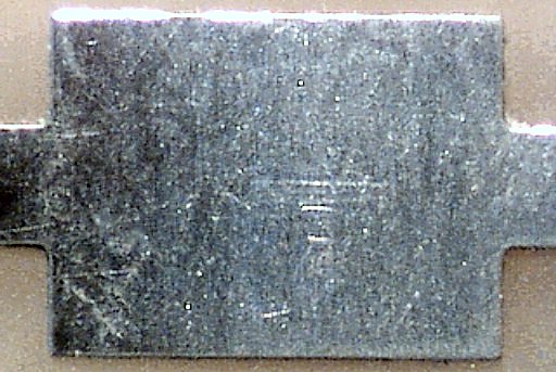 The PCB pad appears fairly clean at 60x magnification after a tap water rinse and brief wash cloth dry.