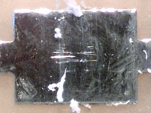 Tarnish was not removed from a printed circuit board pad with a plastic eraser (60x magnification).