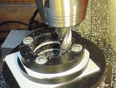 Expanding a hole on a rotary table with a roughing end mill.