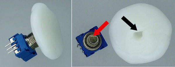 Homemade potentiometer dial with D shape formed in plastic.