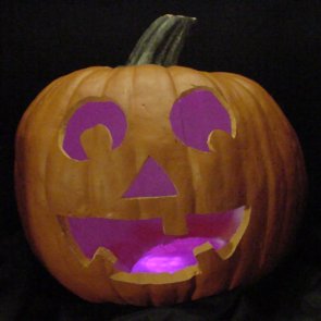 Pumpkin lit with pink LEDs instead of a candle.