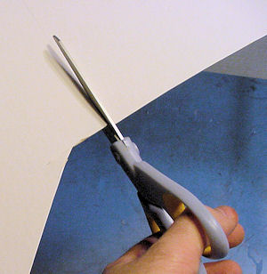 Cutting paper board with scissors