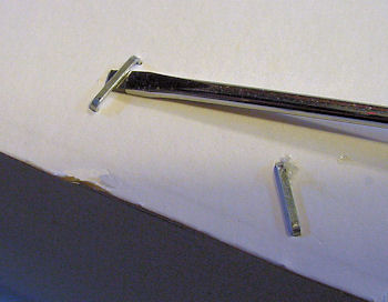 Lifting errant staple with screwdriver