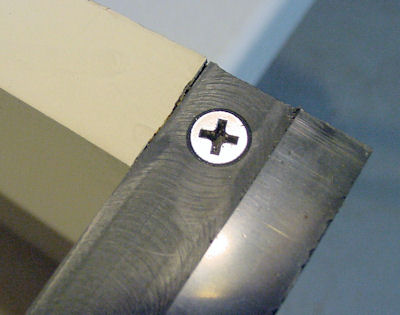 Lip screwed in place with countersunk flathead screw