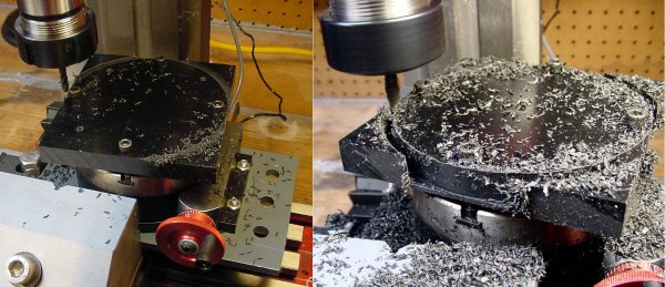 A milling machine cuts out a disc from a black plastic plate on a rotary table.