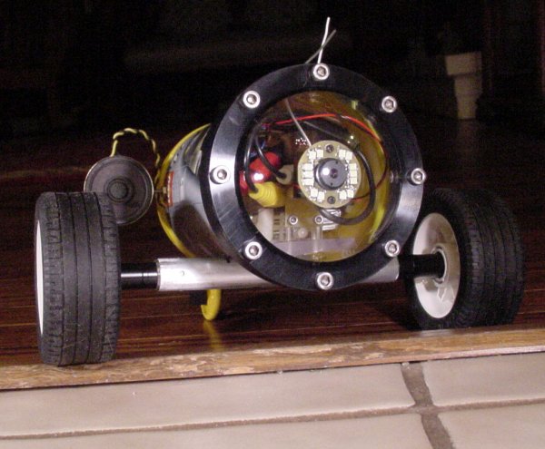 Semi-autonomous robot driving over a wooden room threshold about 3/4-inch high.