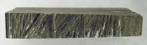 A nasty scrap of ABS plastic with gouges and scratches.