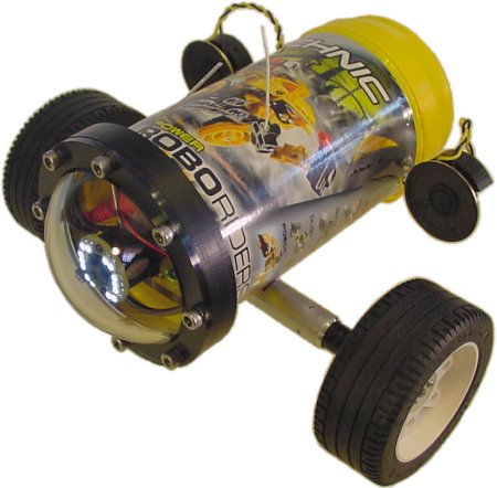 A robot with a wireless camera, white-LED ring light, wireless data connection, large wheel clearance, and two rear-mounted speakers for the speech module.