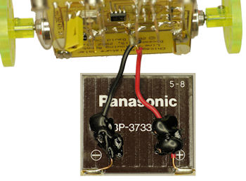 Hot glue secures wires to solar panel