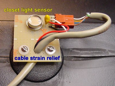 A small circuit atop the brine tank lid contains a light sensor, capacitor, and cable connector. (Note: Something is wrong with this setup.)