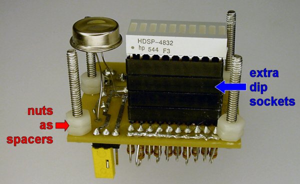Nylon nuts and extra DIP sockets space the display far enough through the wall.